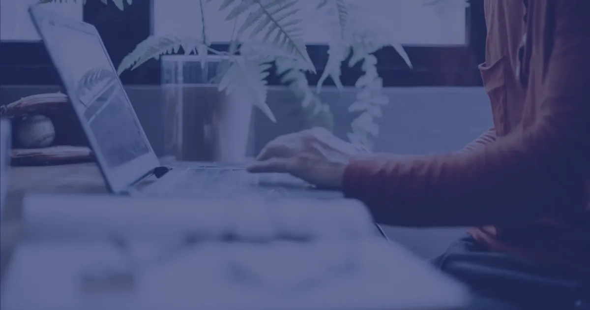 Professional working on a laptop, evaluating whether custom software could replace underused SaaS tools